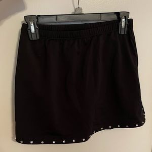 Motionwear black skort with slits on the sides and silver rhinestone trim.